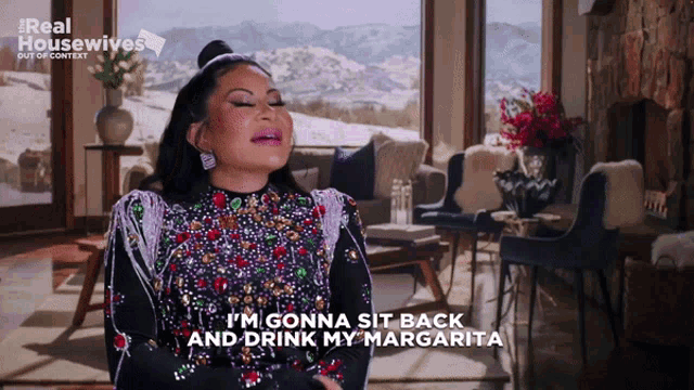 a woman says i 'm gonna sit back and drink my margarita while sitting in a living room
