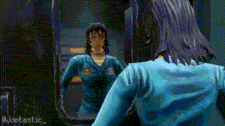 a woman in a blue shirt is looking at herself in a mirror
