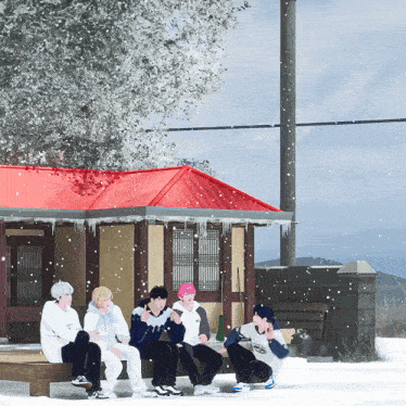 a group of people are sitting outside in the snow