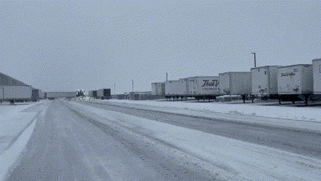 a row of white trucks with the word trust on them