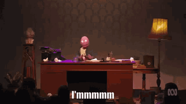 a cartoon character sits at a desk and says i 'm fucked i 'm fucked
