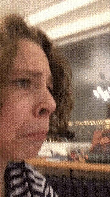 a close up of a woman 's face making a funny face