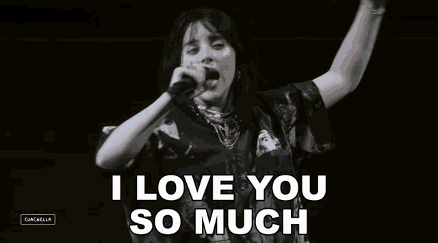 billie eilish singing into a microphone with the words i love you so much below her