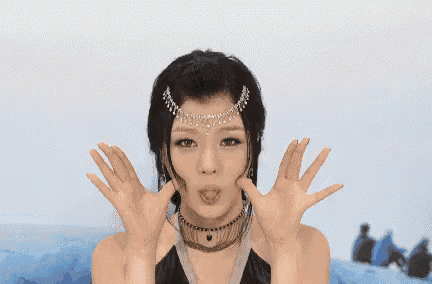 a woman wearing a necklace and a headband is making a funny face .