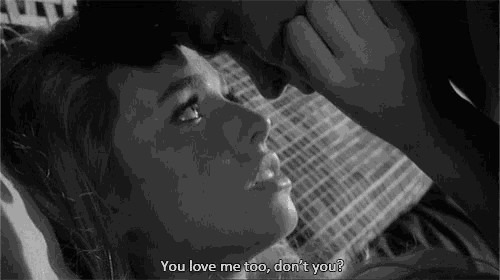 a black and white photo of a man kissing a woman with the caption you love me too don 't you ?