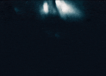 a silhouette of a person with horns in a dark room
