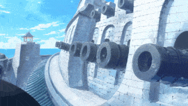 a brick wall with cannons on it and a lighthouse in the background