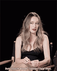 a woman is sitting in a chair and saying `` but touch wood `` because i said that .