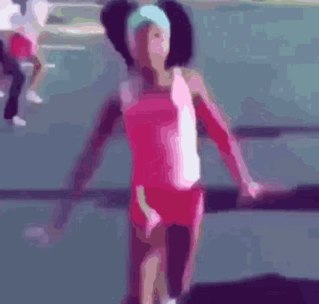 a blurry picture of a girl in a pink outfit