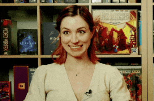a woman stands in front of a shelf with a box that says ex libris on it