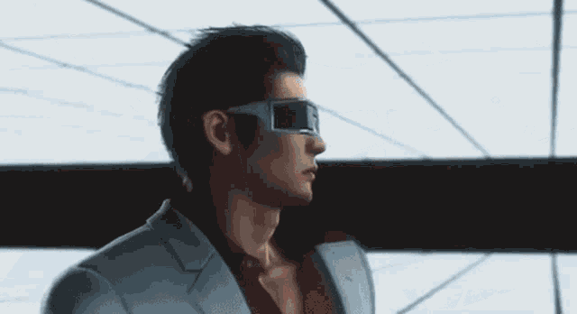 a man in a suit and sunglasses is dancing on a white tiled floor .