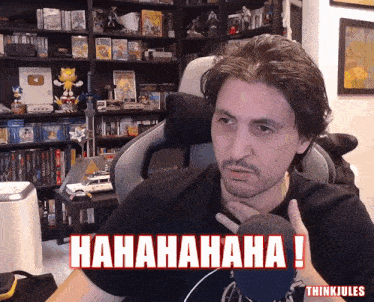 a man sitting in front of a microphone with the words ' hahahaha ! ' on the bottom