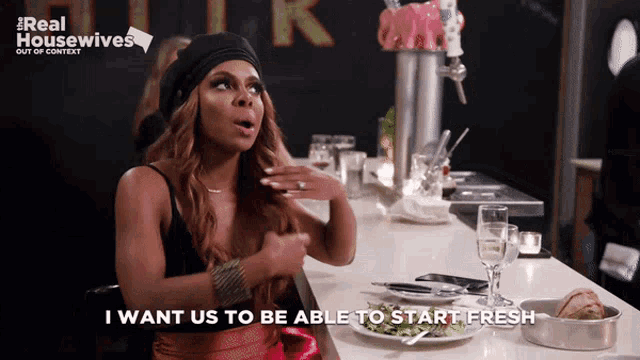 a woman sitting at a bar with the words " i want us to be able to start fresh " above her