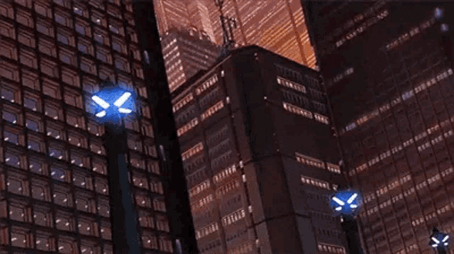 a very tall building with a lot of windows is lit up at night in a city .