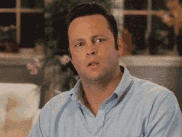 a man in a blue shirt is looking at something