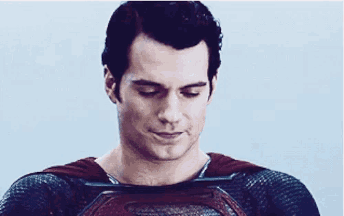 a close up of a man in a superhero costume with his eyes closed .