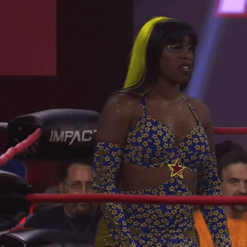 a woman in a blue and yellow outfit is standing in a ring with a sign that says imf