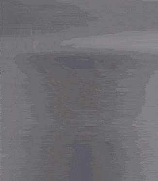 a blurred image of a woman standing in a doorway