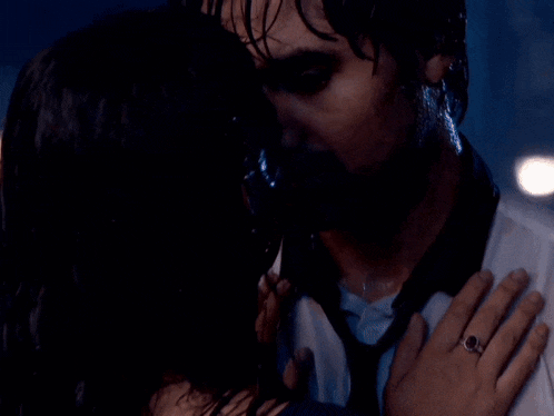 a man and a woman are looking into each other 's eyes