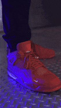 a person is wearing a pair of pink sneakers