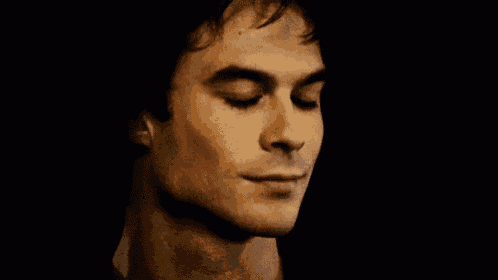a close up of a man 's face with his eyes closed and his mouth open .