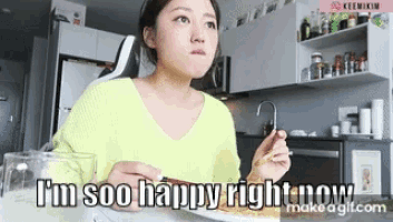 a woman is sitting at a table with a plate of food and the words " i 'm soo happy right now "