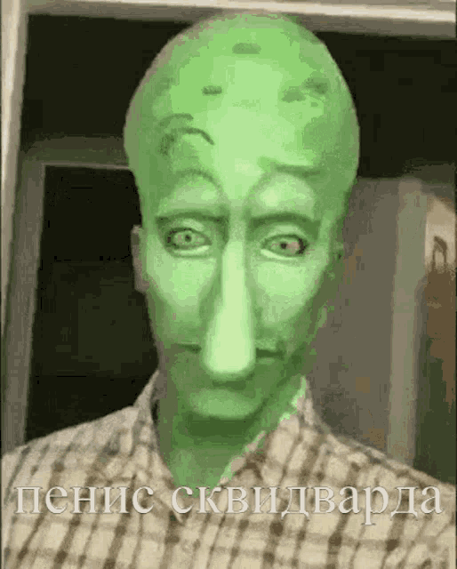a man with a green face and a plaid shirt has a squidward tentacle on his head .