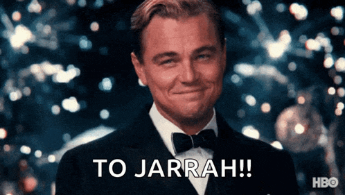 a man in a tuxedo is smiling and says to jarrah !