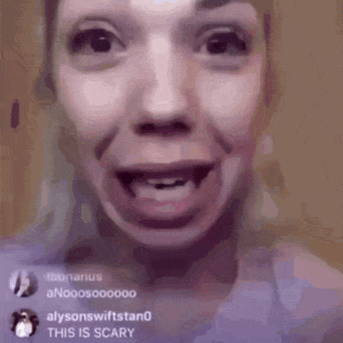 a close up of a woman 's face with her mouth open and a surprised look on her face .