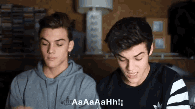 a boy wearing a gray sweatshirt that says " activ "
