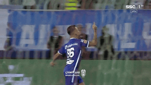 a soccer player wearing a blue jersey with the number 35 on it