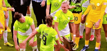 a soccer player wearing a number 9 jersey is holding a trophy