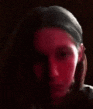 a close up of a person 's face with a red light shining on it