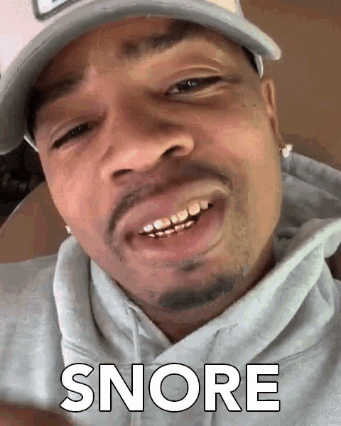 a close up of a man 's face with the word snore written on it