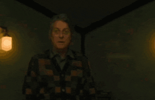 a blurred image of a dark room with a few lights visible