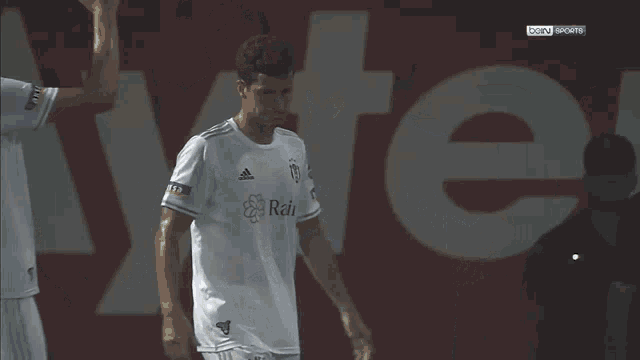 a soccer player wearing a beko jersey is hugging another soccer player