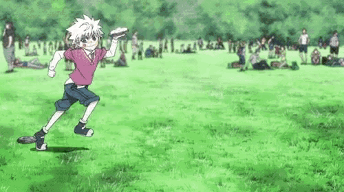 a boy in a pink shirt is running in a grassy field