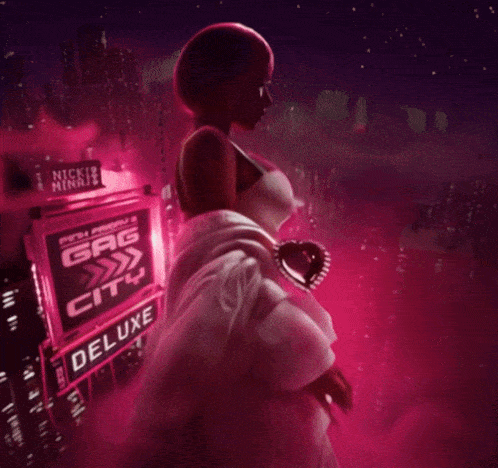 a woman stands in front of a sign that says ' nicki minaj ' on it