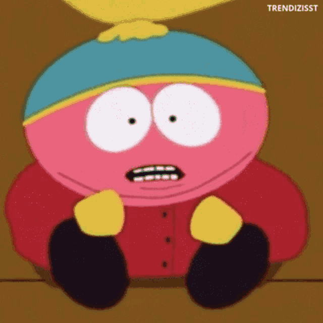 a cartoon character from south park is sitting on the floor and making a surprised face .