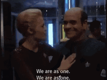 a man and a woman are standing next to each other and the woman says we are as one we are as one