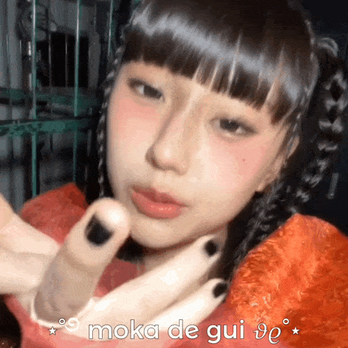 a close up of a girl with the words moka de gui on the bottom
