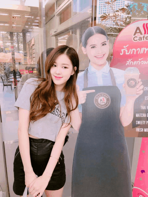 a girl standing next to a sign that says all cafe on it