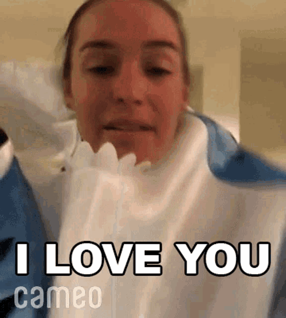 a woman is wearing a blue and white shirt and saying i love you cameo .