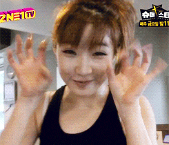 a woman is waving her hands in front of a sign that says ' znetv ' on it