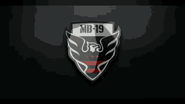 a black and white emblem with the letters mb-19 on it