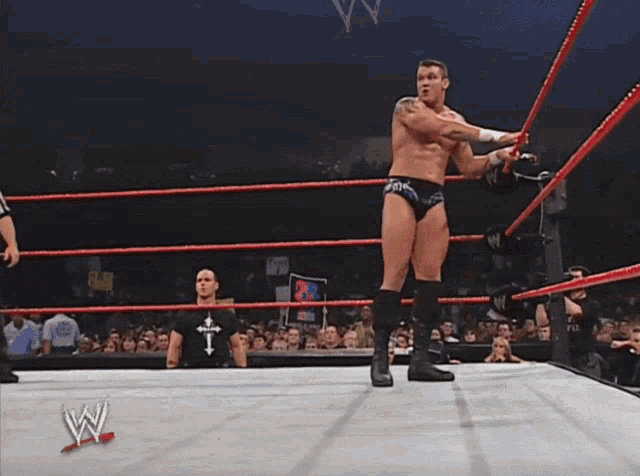 two wrestlers are in a wrestling ring with a sign that says raw