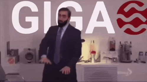 a man in a suit and tie is dancing in front of a sign that says gigas