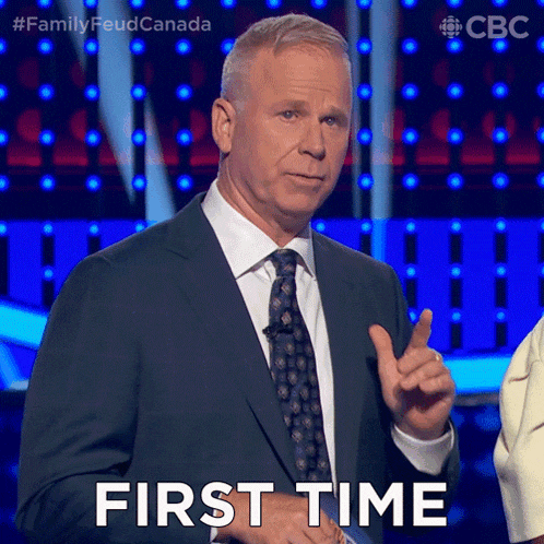 a man in a suit and tie says first time in front of a blue background