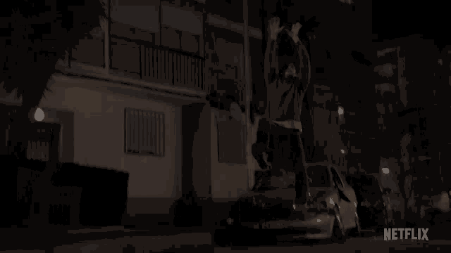 a man is standing on top of a car with netflix written on the bottom