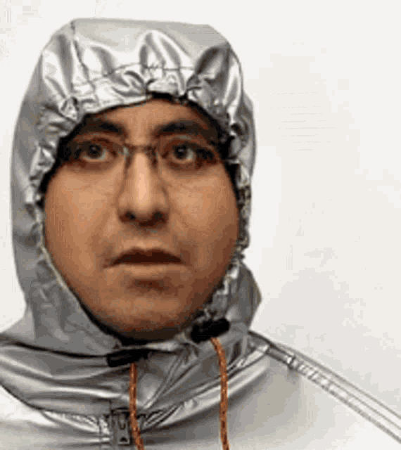 a man wearing a hooded jacket and glasses